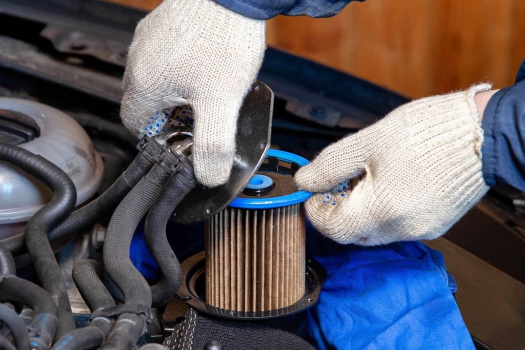 The-mechanic-takes-out-the-old-dirty-fuel-filter-to-replace-it-in-the-car-with-a-new-one.jpg